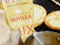 Preparing to infuse the sponges with the zesty drizzle.
