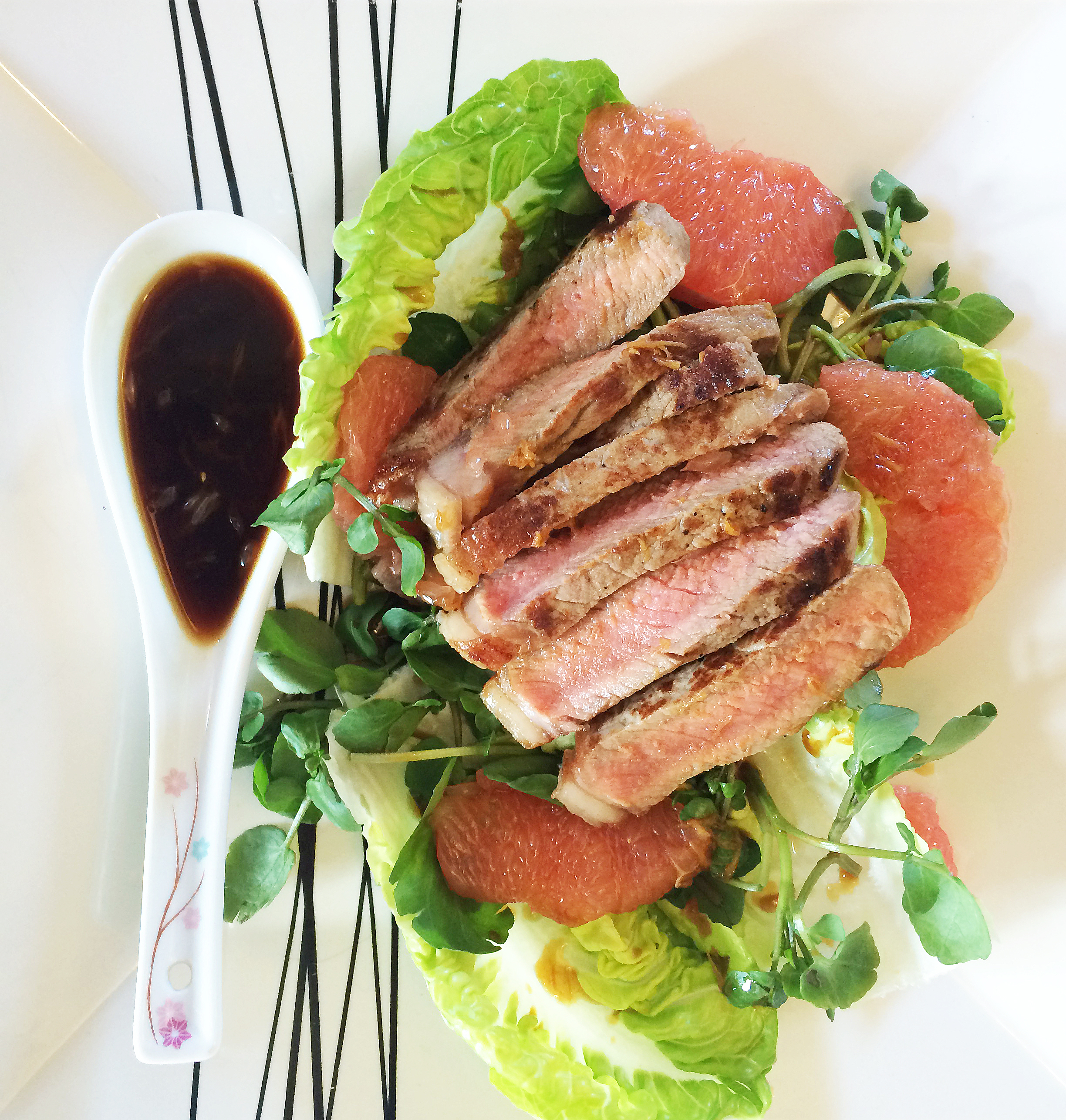 Seared steak with pink grapefruit salad